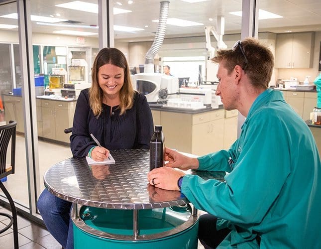 Two people discussing a product