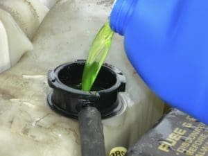 Pouring antifreeze into vehicle